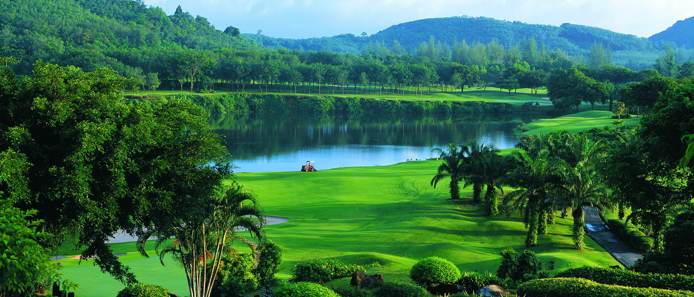 Golfers enjoying a serene game amid lush greens and scenic views in Khao Lak
