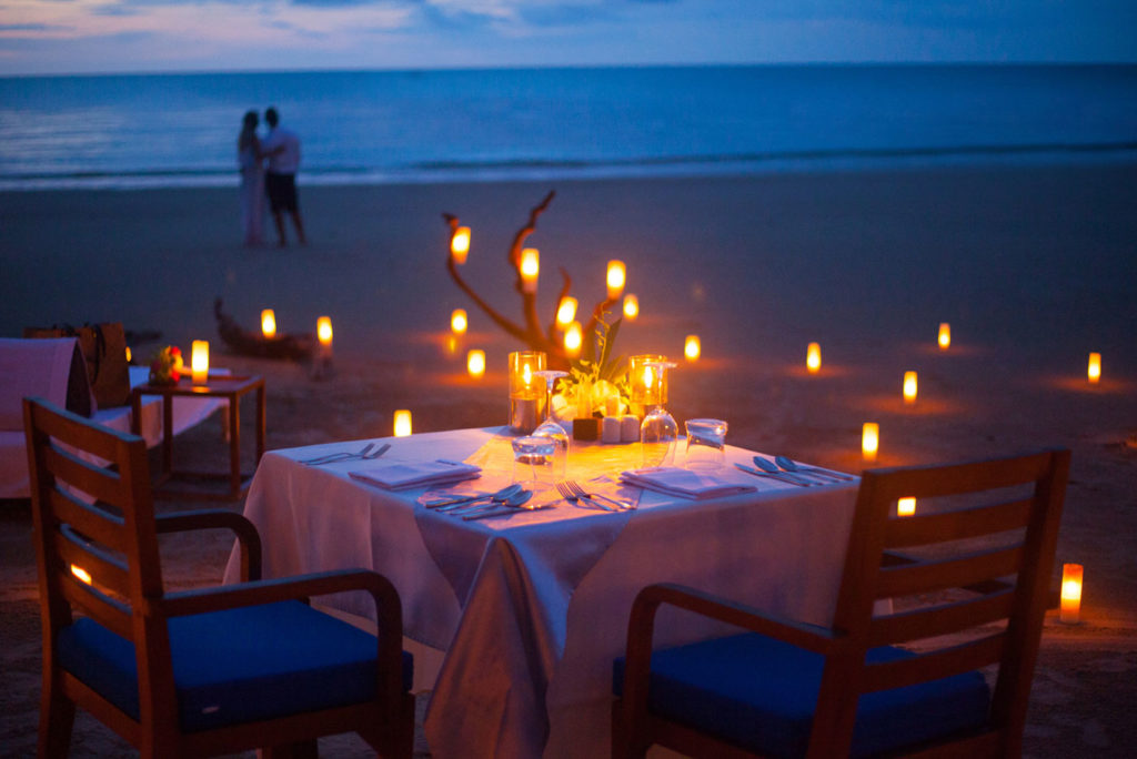 Exquisite private dining on The Sarojin's white sand beach, a romantic setting.